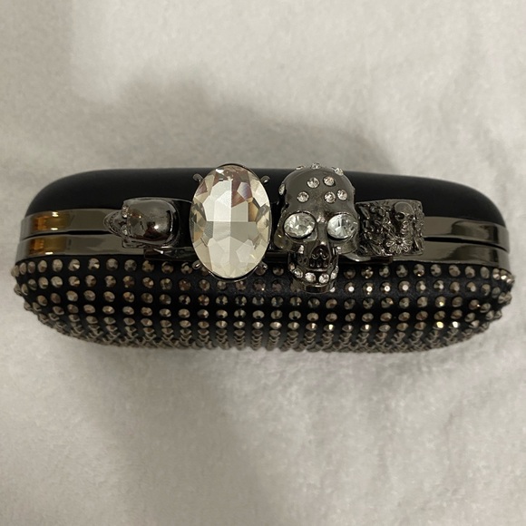 Skull Ring Knuckle Clutch with Chain Strap
McQueen inspired studded design - Picture 2 of 10